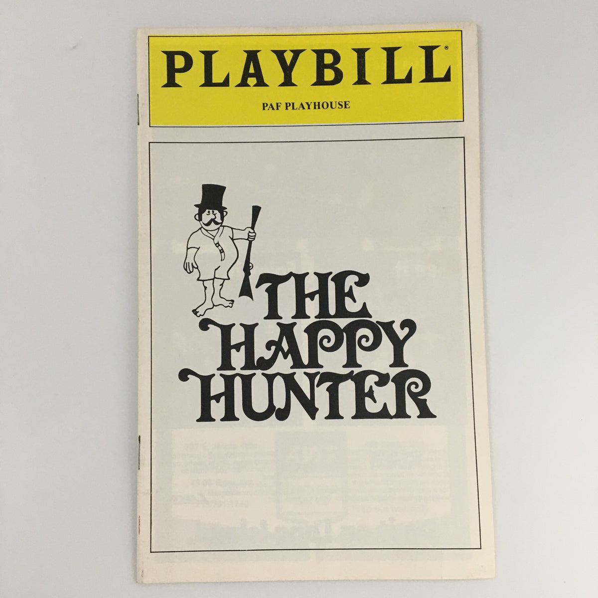 Cover of the 1980 Playbill for 'The Happy Hunter' at PAF Playhouse featuring a whimsical design and title.