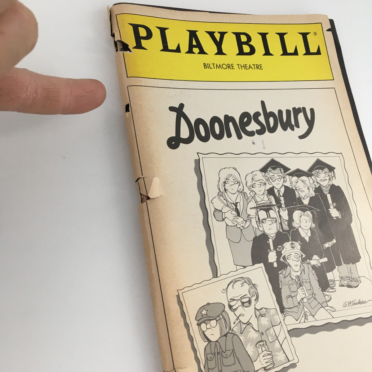 Close-up view of the 1983 Playbill for 'Doonesbury' at the Biltmore Theatre, highlighting the cover design and condition details.