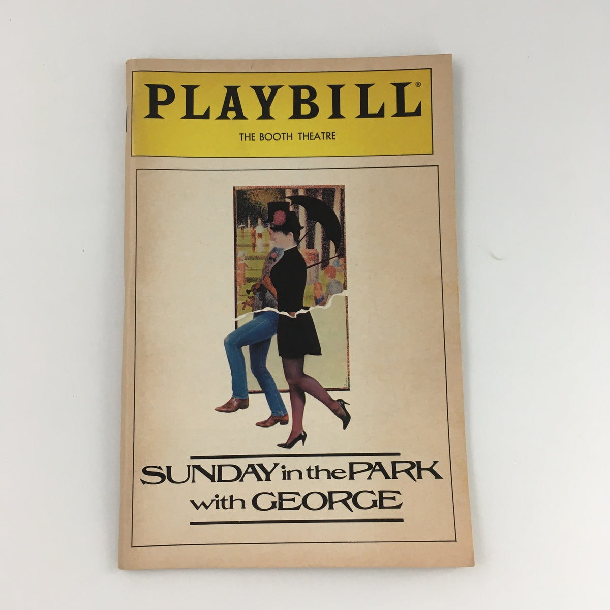 1984 Playbill for Sunday in the Park with George at The Booth Theatre, showcasing iconic cover art featuring a stylish figure in a park setting.