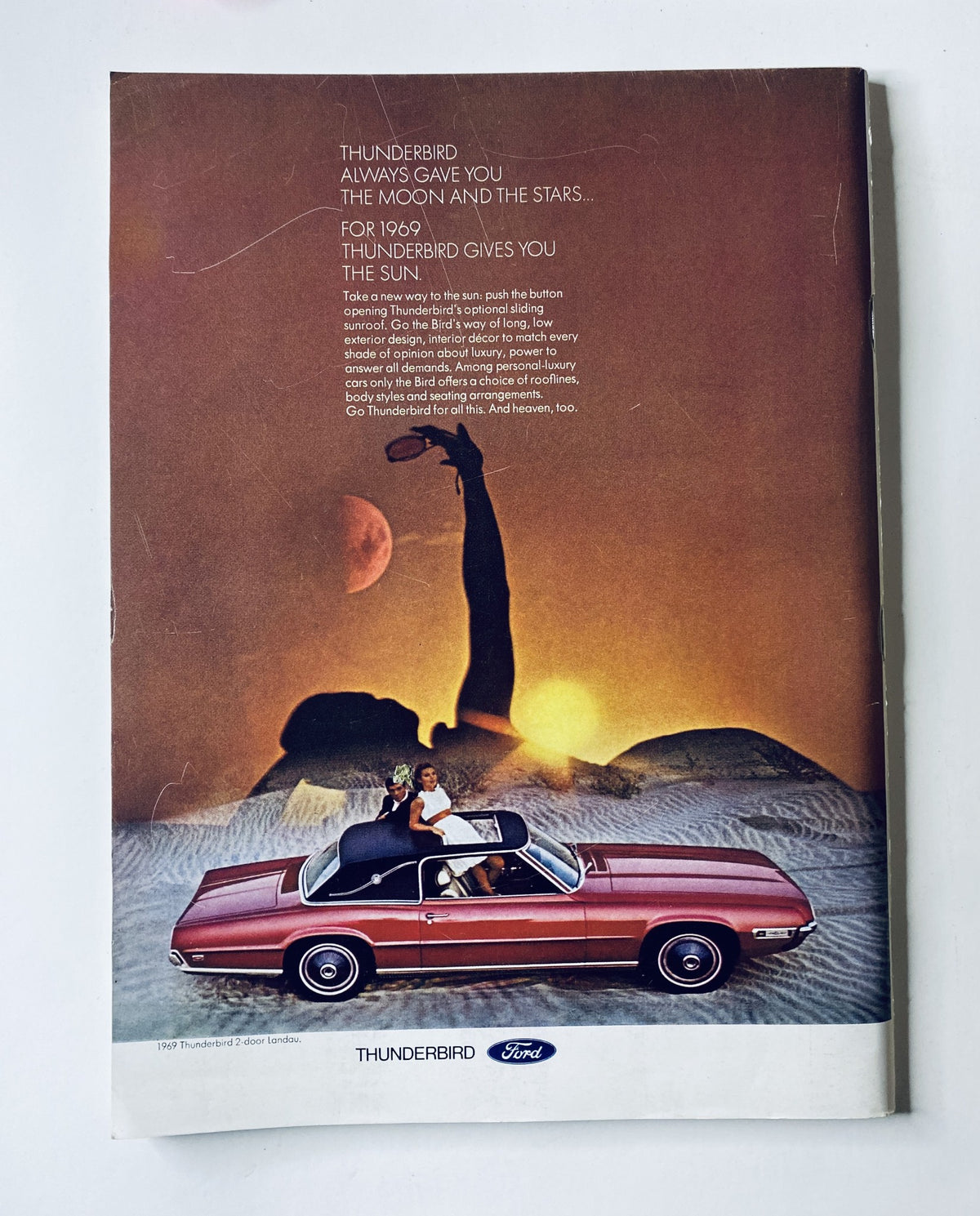 1980s Thunderbird Ford advertisement in The New Yorker Magazine April 12, 1969, featuring a convertible and a sunset background.