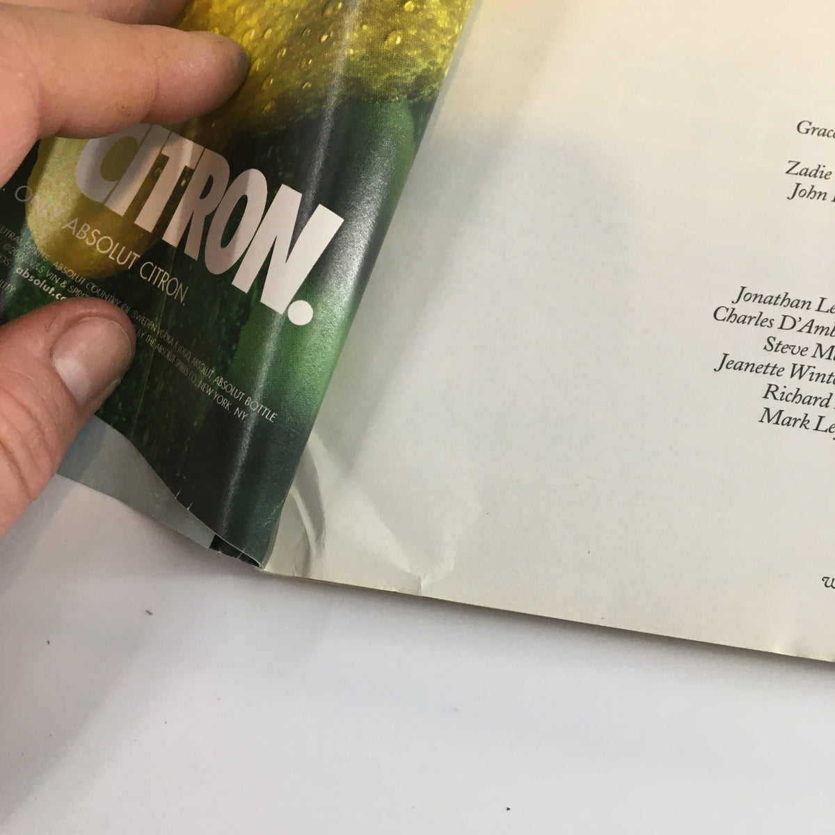 Interior page of The New Yorker Full Magazine June 17 2002 showing a hand holding the magazine with visible wear and a small rip.