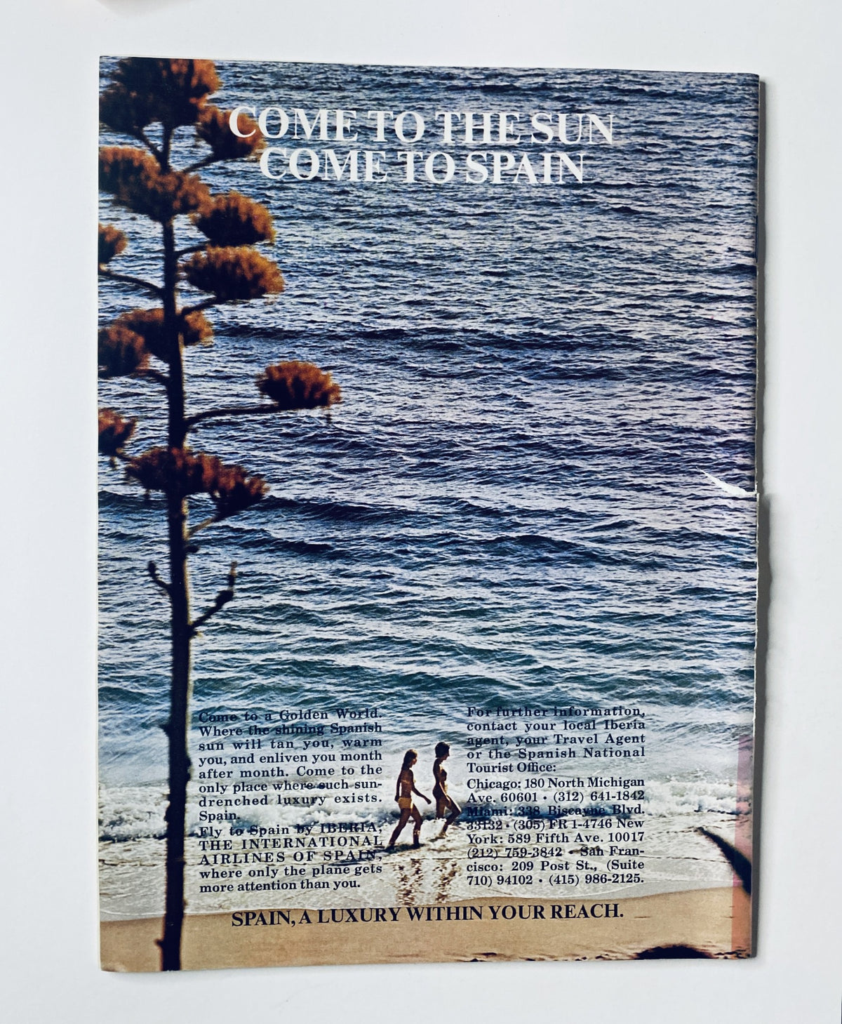Back cover of The New Yorker Magazine January 1, 1972 promoting travel to Spain with a scenic beach view and a tree silhouette.