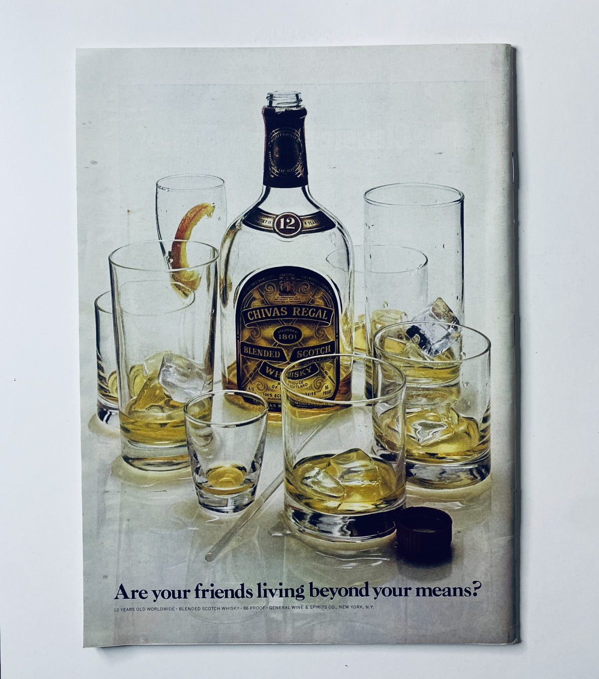 Advertisement page in The New Yorker Magazine June 19, 1971 showcasing a bottle of Chivas Regal whiskey among empty glasses with ice.