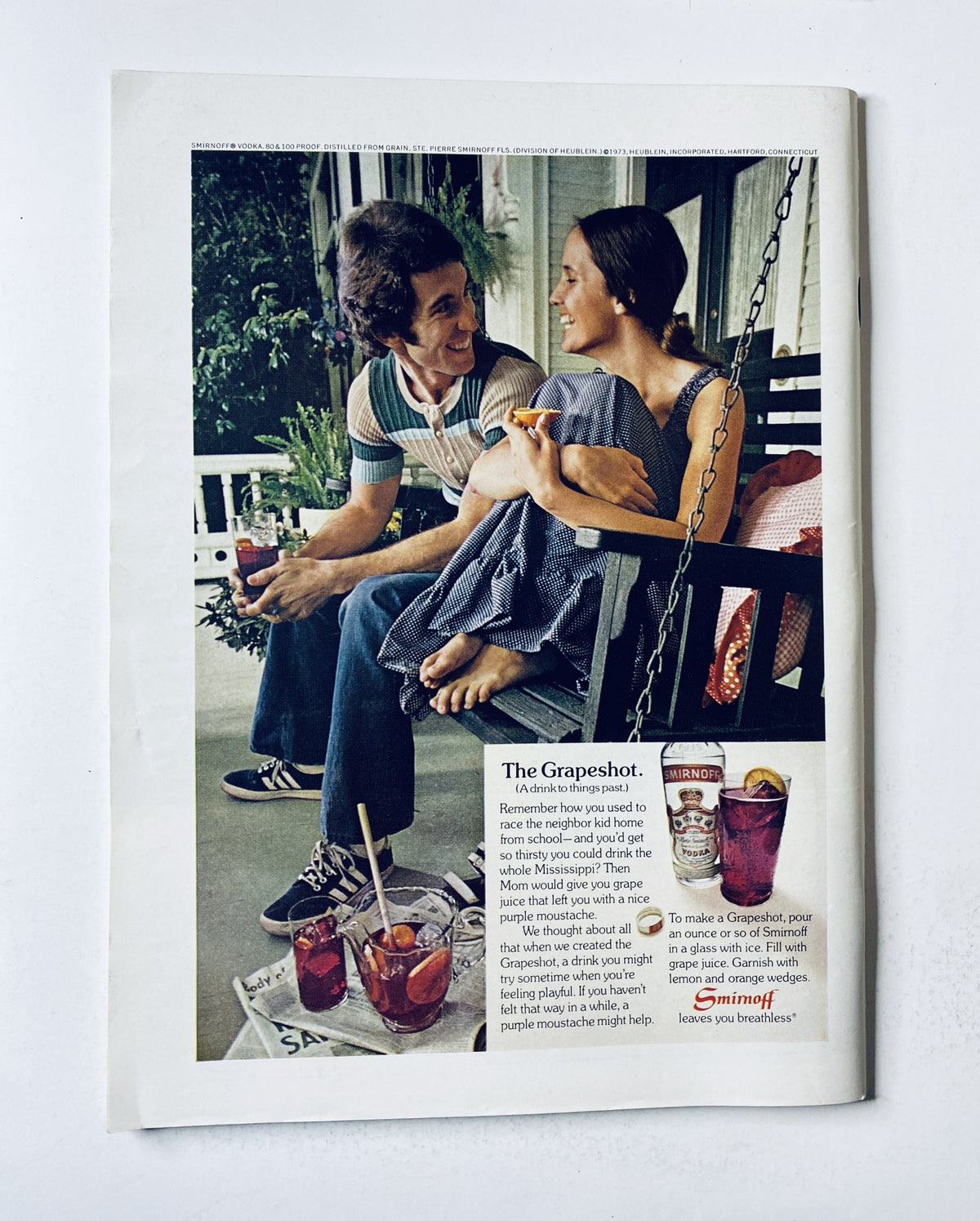 The New Yorker Magazine May 5, 1973 features a vintage advertisement titled 'The Grapeshot,' showcasing a couple enjoying drinks on a porch swing, highlighting a nostalgic moment with cocktails.