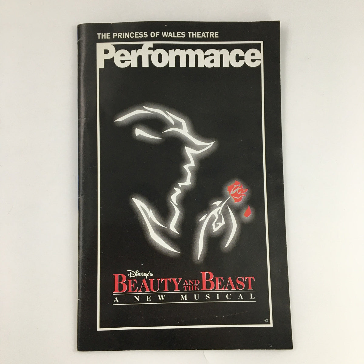 1997 The Princess of Wales Theatre 'Beauty and the Beast' program cover featuring the silhouette of the Beast holding a rose, highlighting the musical's dramatic theme.
