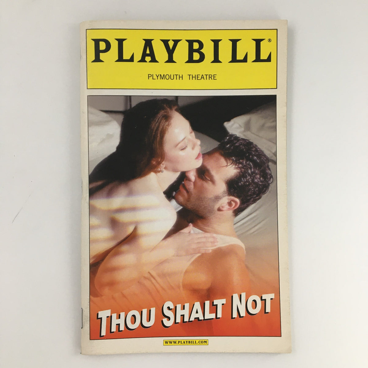 Cover of the 2001 Playbill from Plymouth Theatre for 'Thou Shalt Not,' featuring a Romantic scene between a man and a woman.
