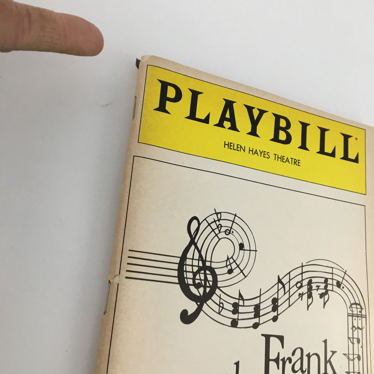 Close-up view of the 1980 Playbill for 'Perfectly Frank' at the Helen Hayes Theatre highlighting its spine and title.