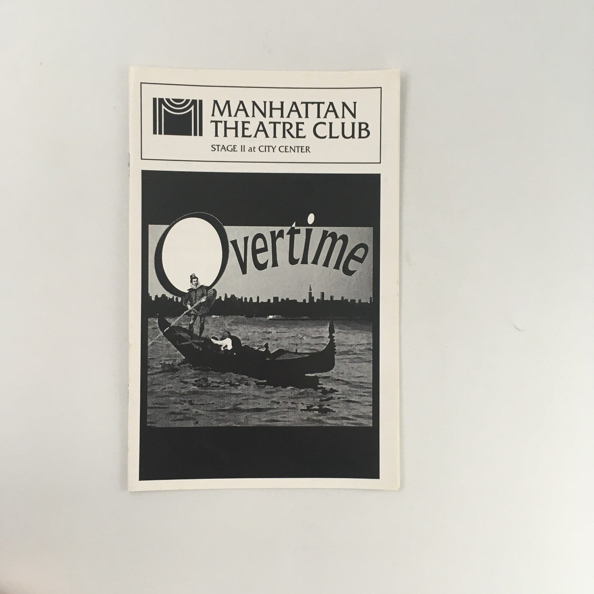 1996 Manhattan Theatre Club 'Overtime' program cover featuring a dramatic black and white design, showcasing a figure in a boat with city skyline in the background.