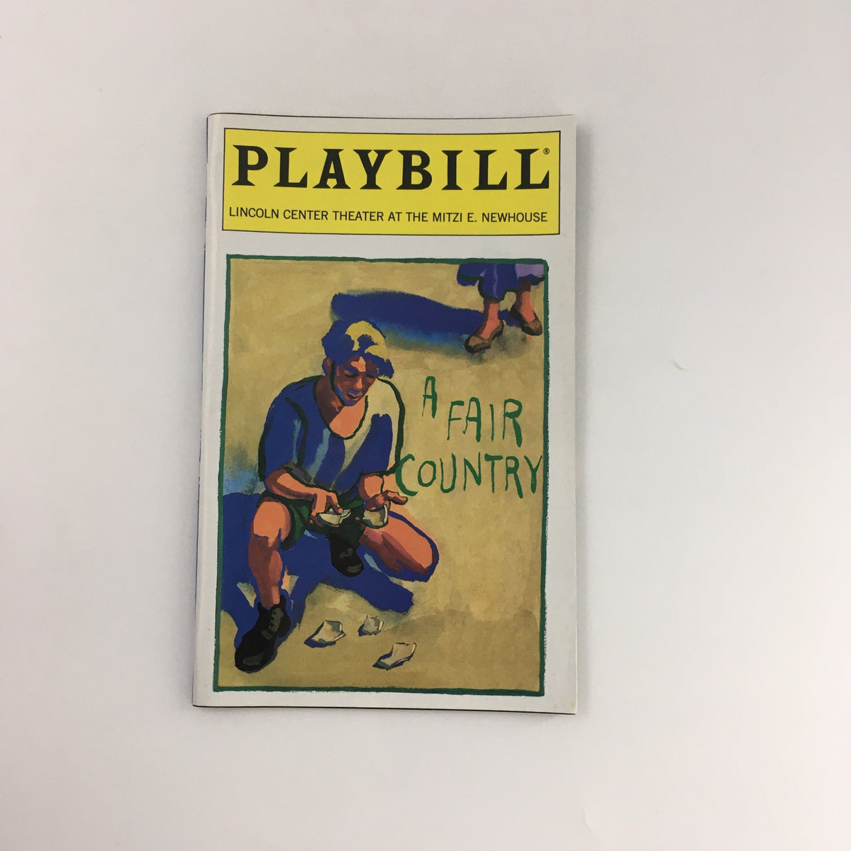 1996 Playbill for 'A Fair Country' at Mitzi E. Newhouse Theater showcasing cover art depicting a character seated on the ground with the title prominently displayed.