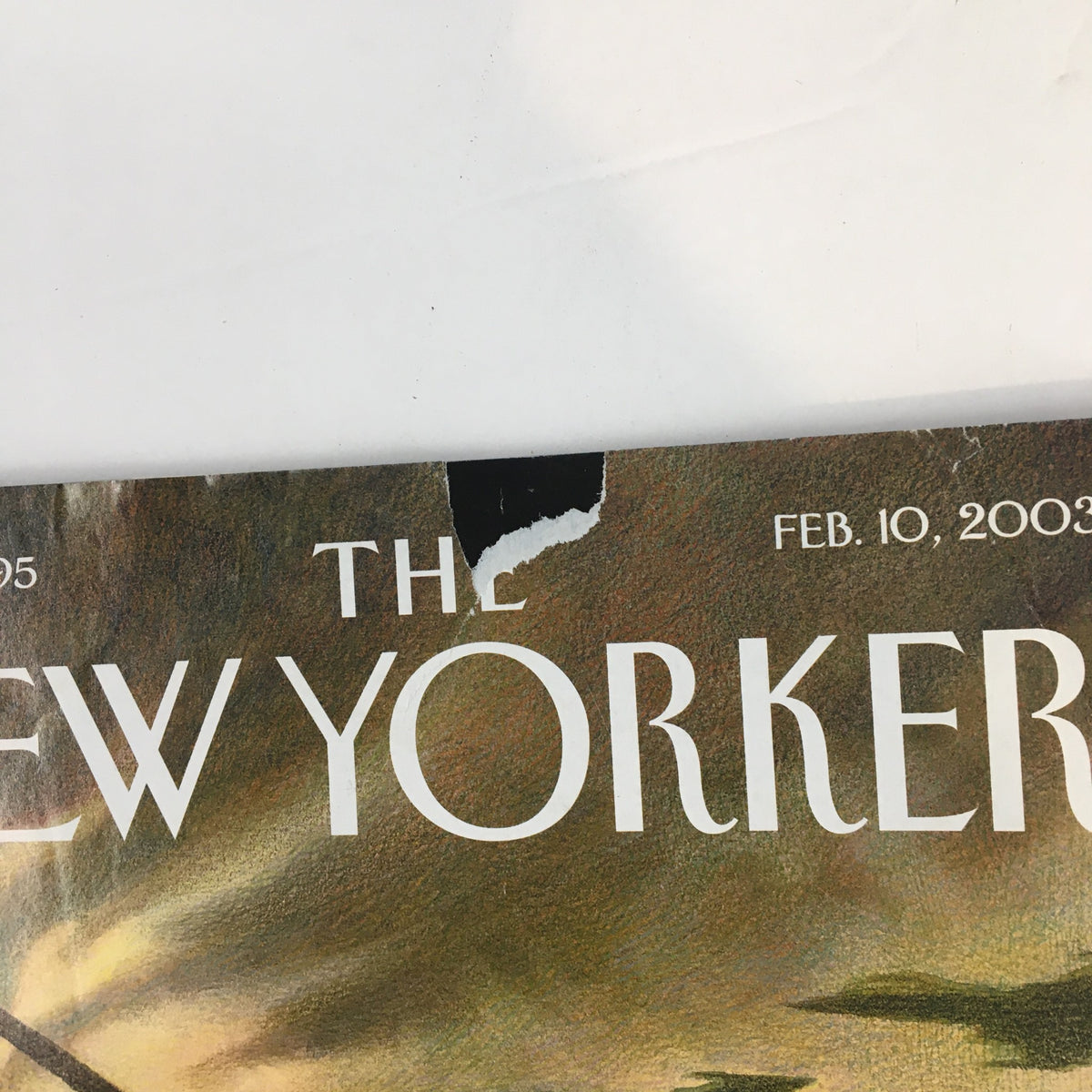 Close-up of the top edge of The New Yorker Full Magazine February 10 2003, showing a minor tear and the publication date, February 10, 2003.