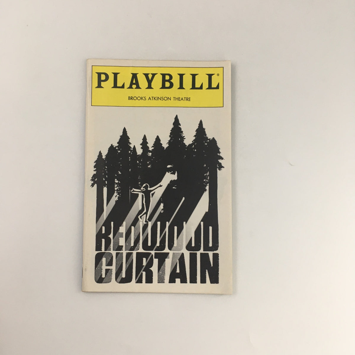 1993 Playbill from Brooks Atkinson Theatre featuring 'Redwood Curtain', showcasing a striking cover design with forest silhouettes and a figure, ideal for theater memorabilia collectors.