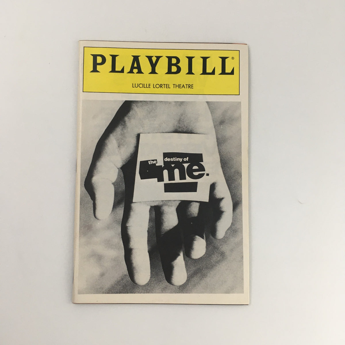 1992 Playbill for 'The Destiny of Me' at the Lucille Lortel Theatre featuring a hand holding the cover page.