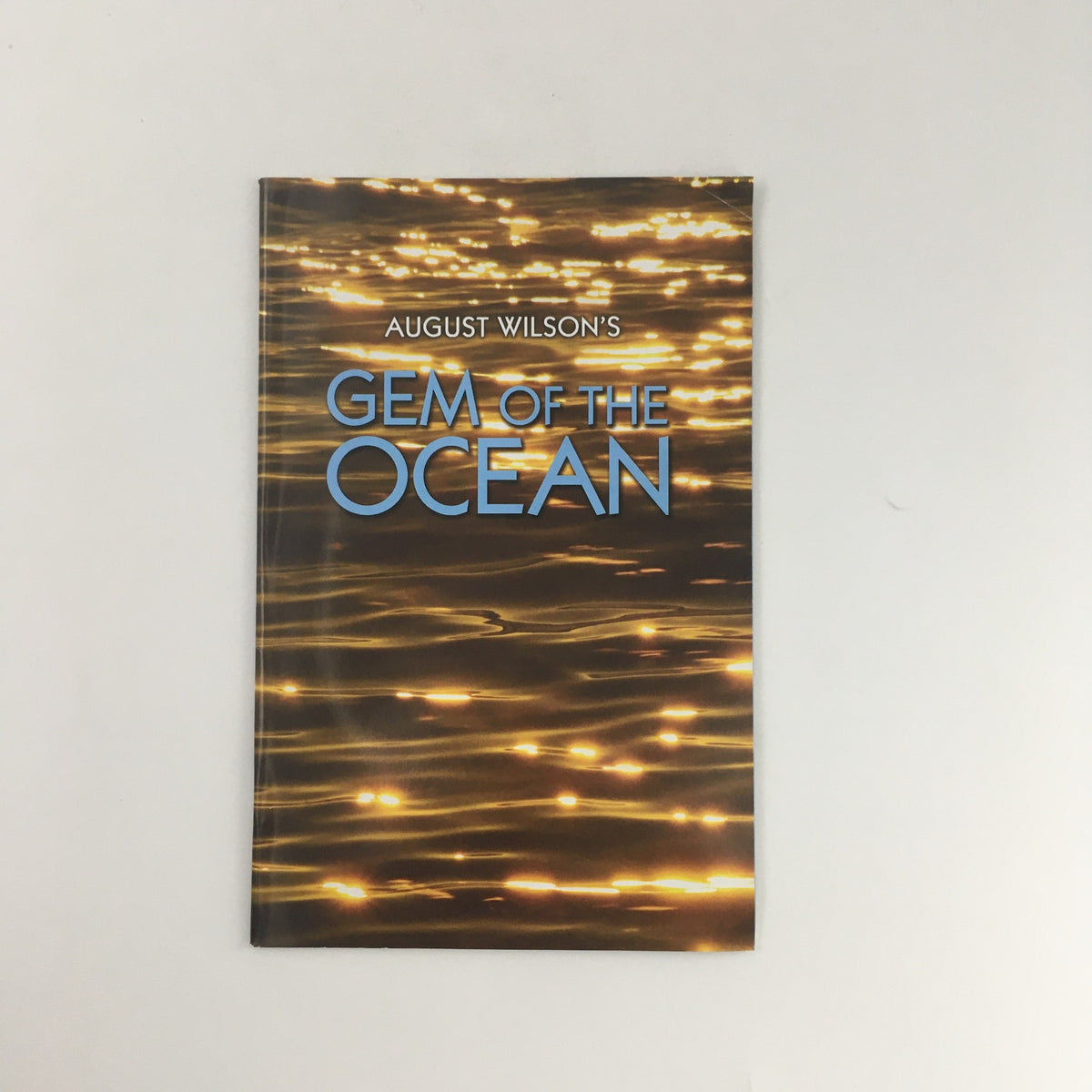 Cover of August Wilson's 'Gem of the Ocean' from the 2005 McCarter Theatre Center production, featuring a shimmering water background and bold title.