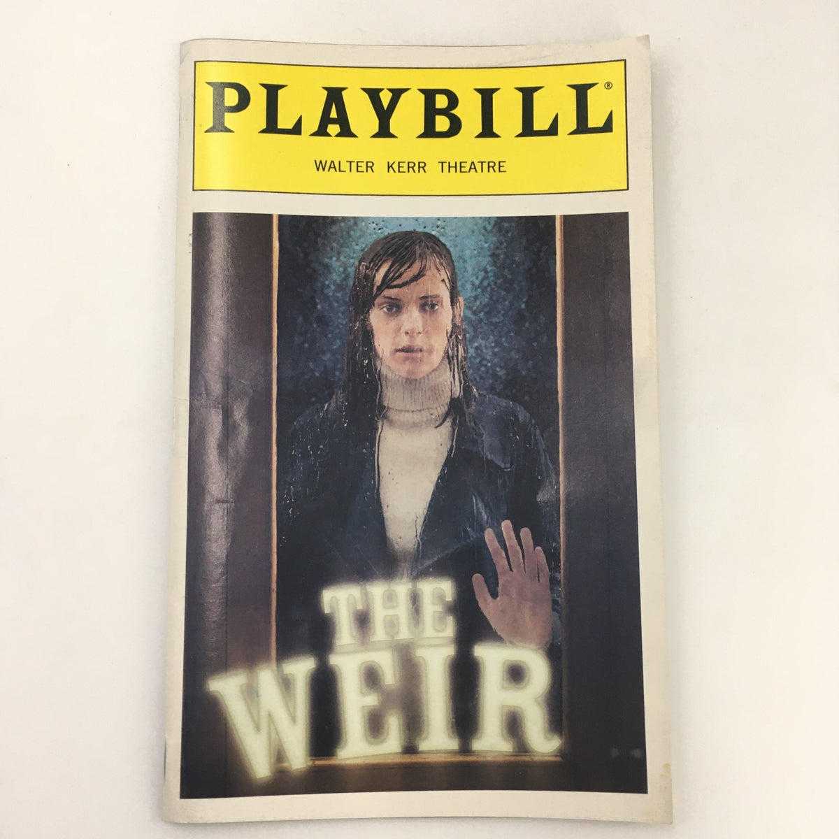 1999 Playbill for 'The Weir' at Walter Kerr Theatre featuring evocative cover image of a person reaching out in the rain.