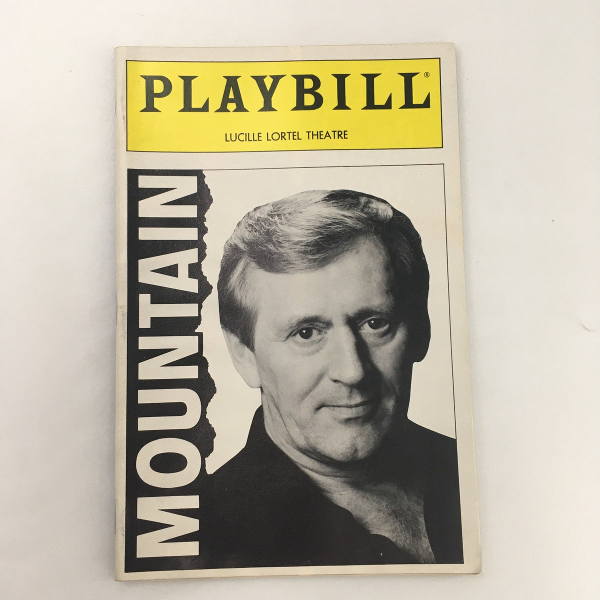 1990 Playbill Lucille Lortel Theatre ‘Mountain’ by Douglas Scott featuring a cover image showcasing the title 'MOUNTAIN' and a portrait of a male actor.