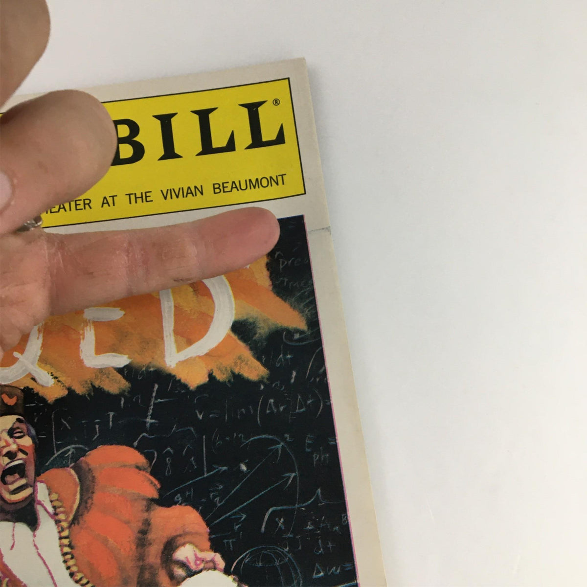 Close-up of the 2001 Playbill QED showing the top corner with the title and character detail.
