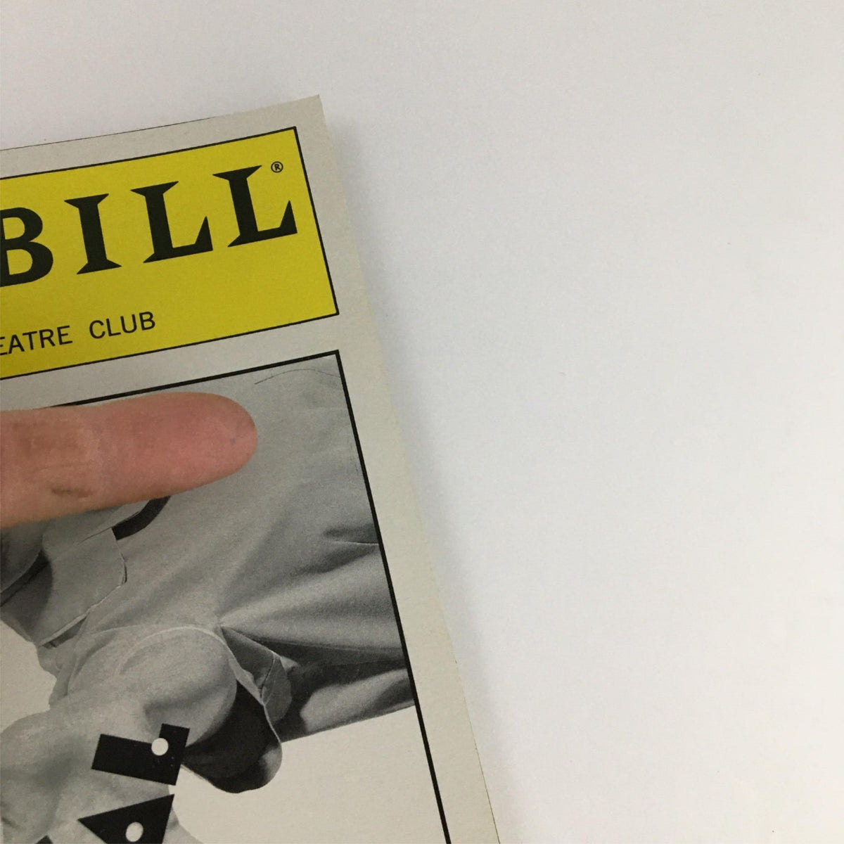 Close-up of the 2000 Playbill for 'Comic Potential' by Manhattan Theater Club, featuring the logo at the top and a hand pointing at it.