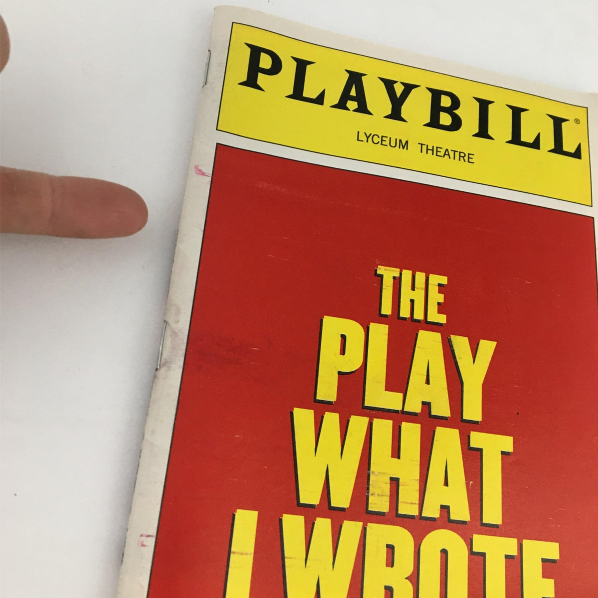 Close-up view of the 2003 Playbill for 'The Play What I Wrote', showing minor wear along the spine and edge.