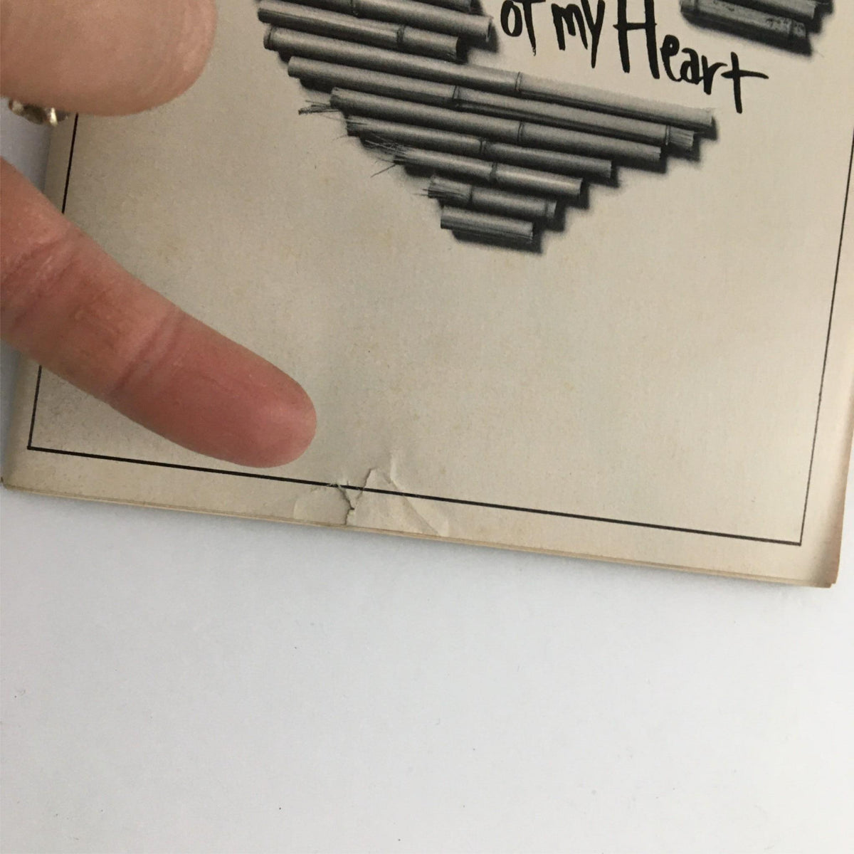 Close-up of the 1991 Playbill for A Piece of My Heart showing minor damage near the bottom edge, highlighting its vintage character.