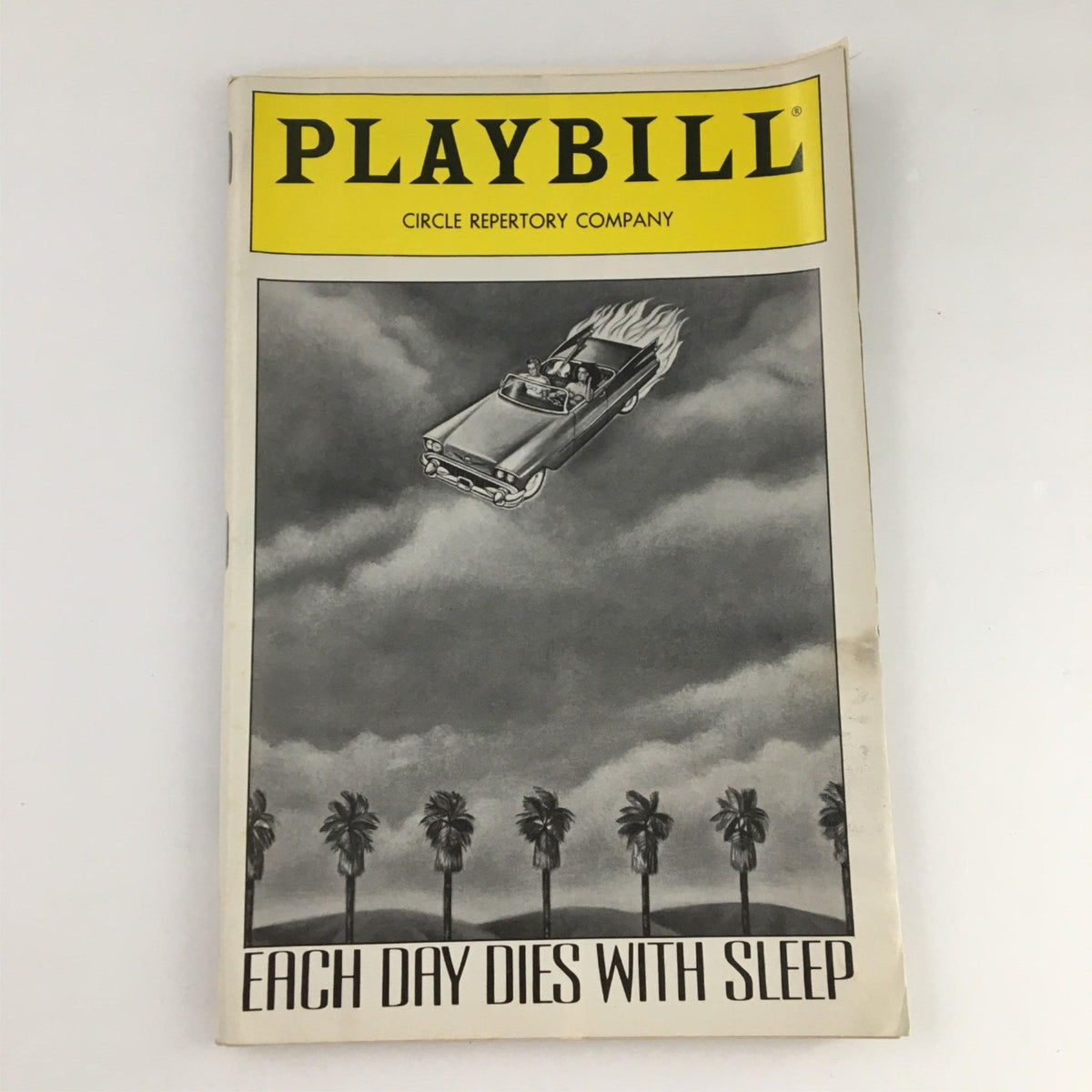 1990 Playbill for 'Each Day Dies with Sleep' by Circle Repertory Company featuring a vintage cover illustration of a car in a surreal landscape.