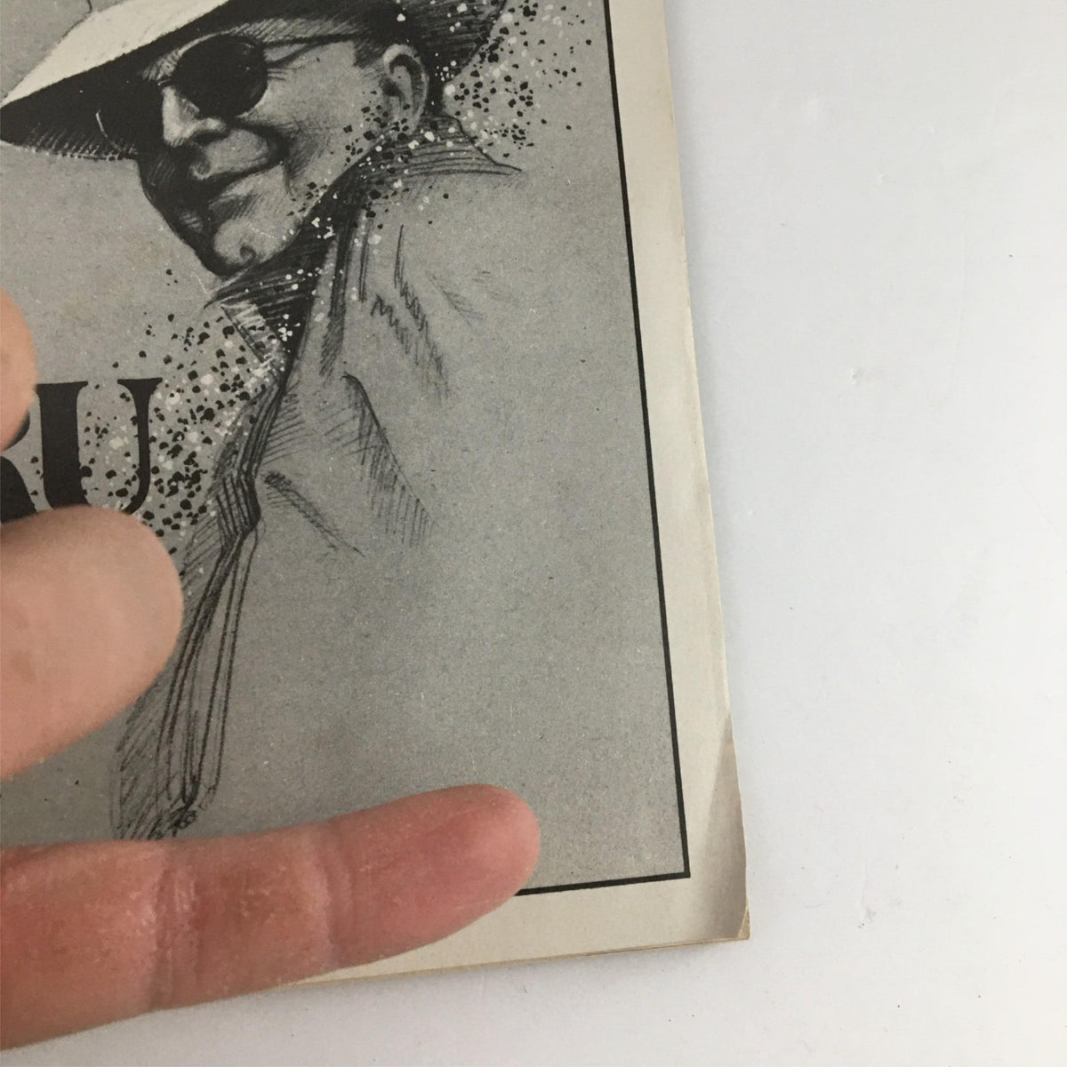 Close-up view of the 1990 Playbill Tru cover from The Booth Theatre, showing the edge of the program and part of the illustration with the title 'TRU' prominently displayed.