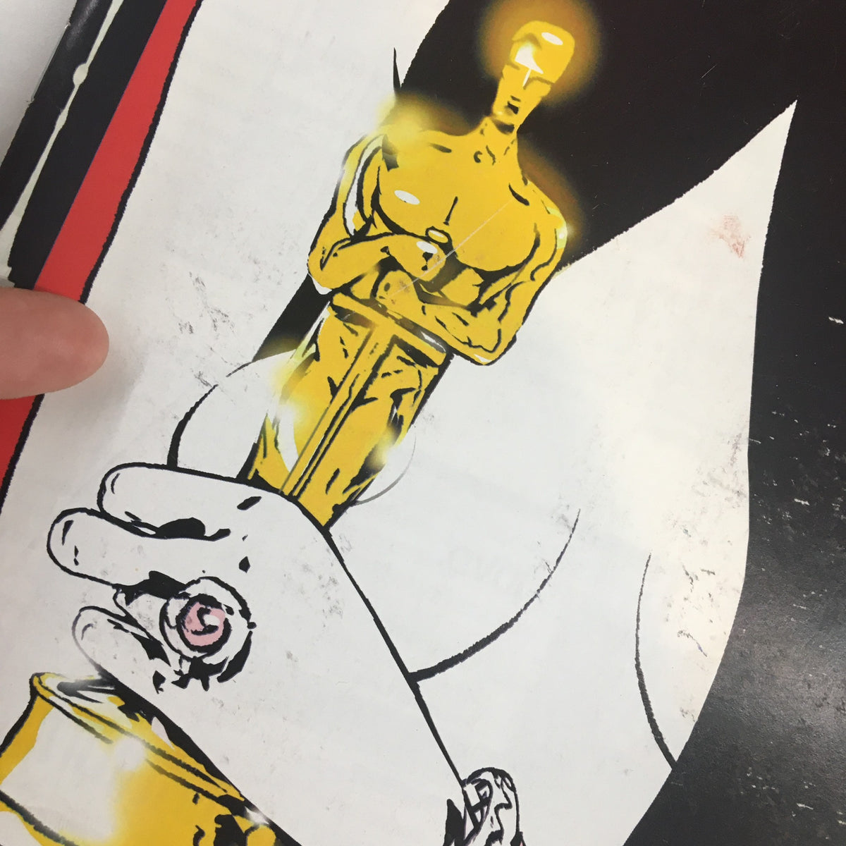 Detailed view of the Oscar statuette held in 'Wardrobe Malfunction' cover art from The New Yorker Full Magazine March 1 2004.