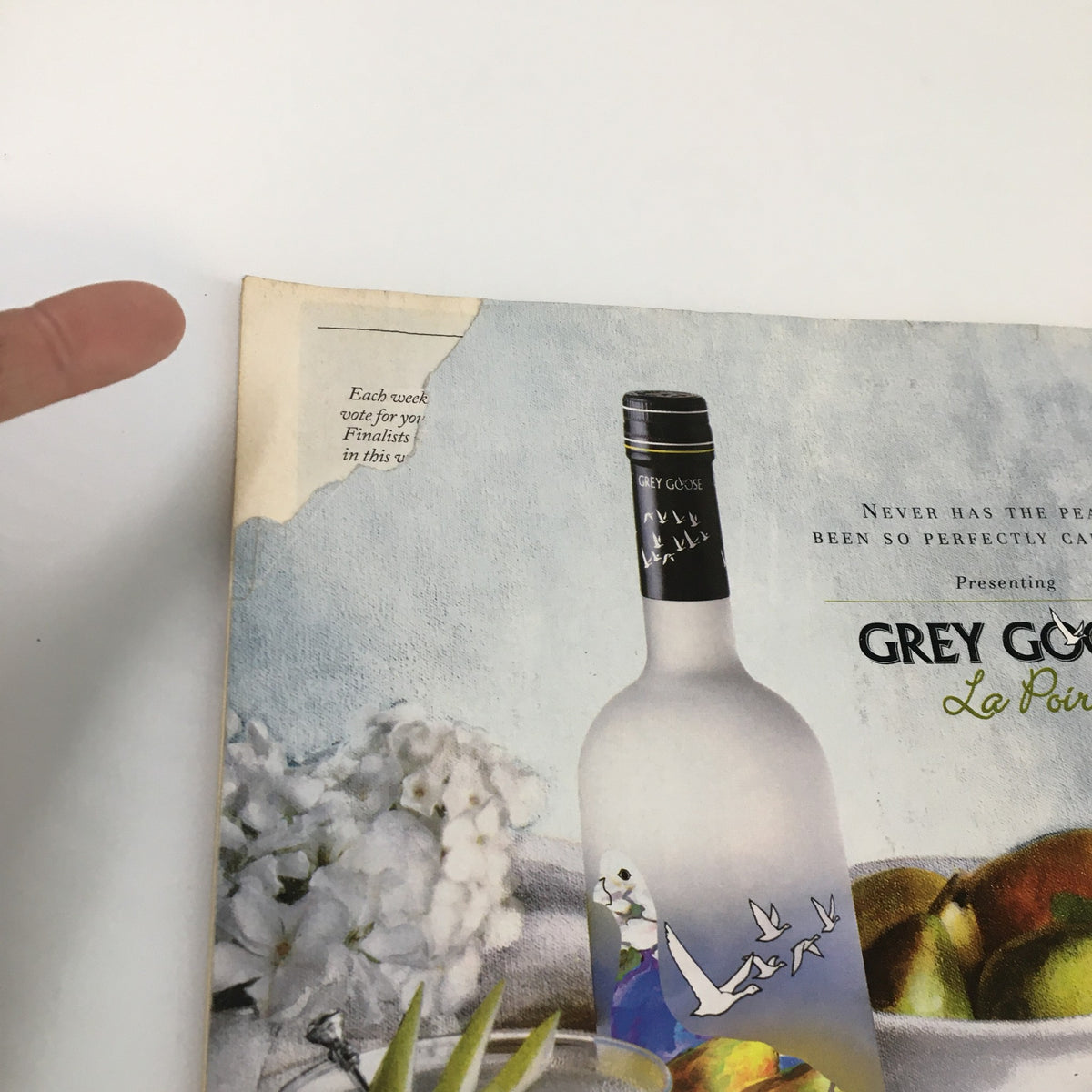 Close-up of an advertisement in The New Yorker magazine, April 9, 2007, showing a partially torn corner, highlighting the vintage character of the issue titled 'T-Day' by Christoph Niemann.