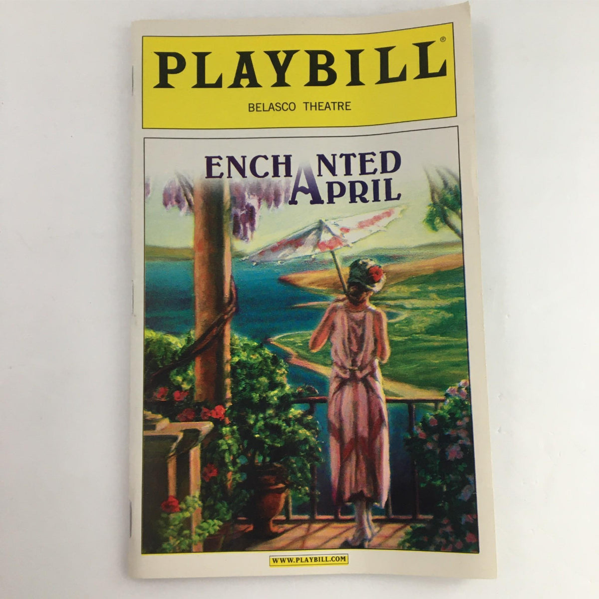 2003 Playbill for Enchanted April at Belasco Theatre featuring vibrant cover art depicting a woman with an umbrella against a picturesque Italian landscape.