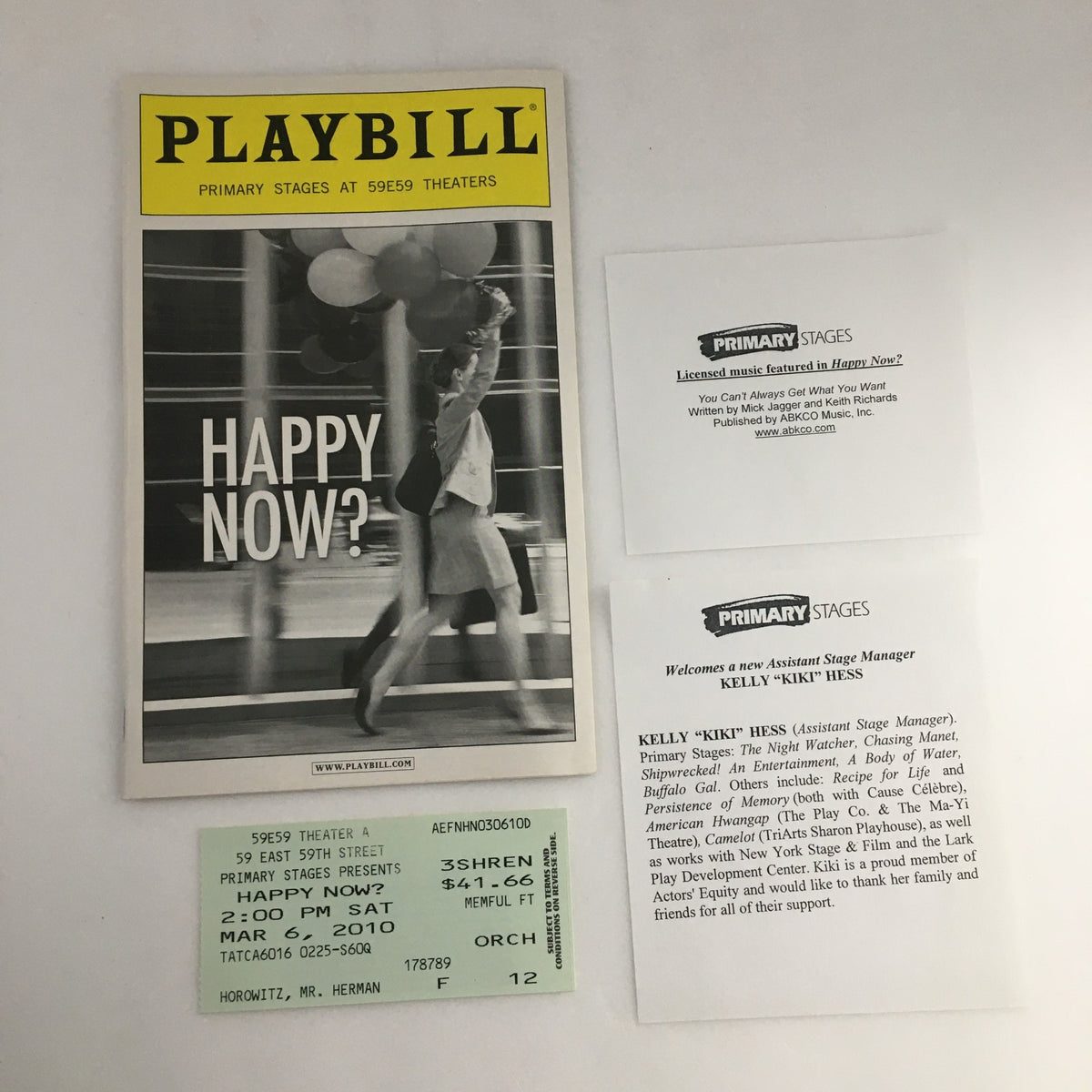 2010 Playbill for 'Happy Now?' featuring the cover design from Primary Stages, showcasing a woman walking with balloons.