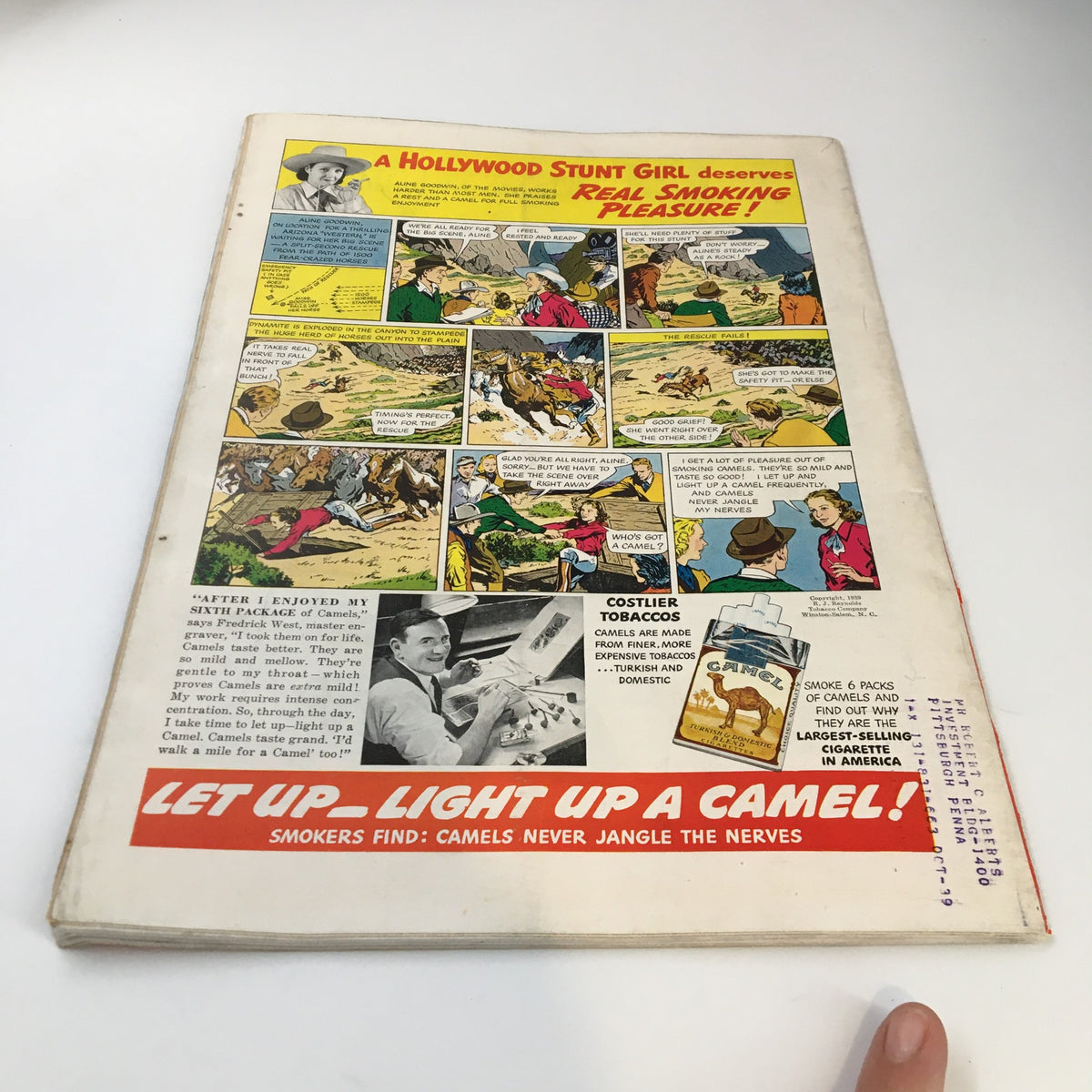 The back cover of VTG Time Magazine from May 8, 1939, featuring a colorful advertisement with a comic strip promoting Camel cigarettes. The ad highlights a Hollywood stunt girl and includes catchy slogans like 'Light up a Camel!' showcasing the vintage style of advertising from the era.