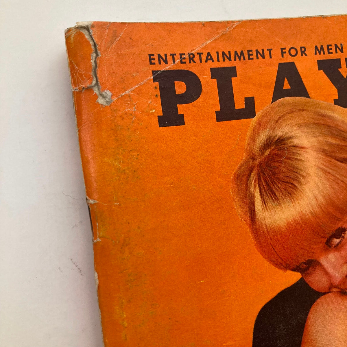 Close-up of the corner of the VTG Playboy Magazine October 1966 showing wear and the title prominently.