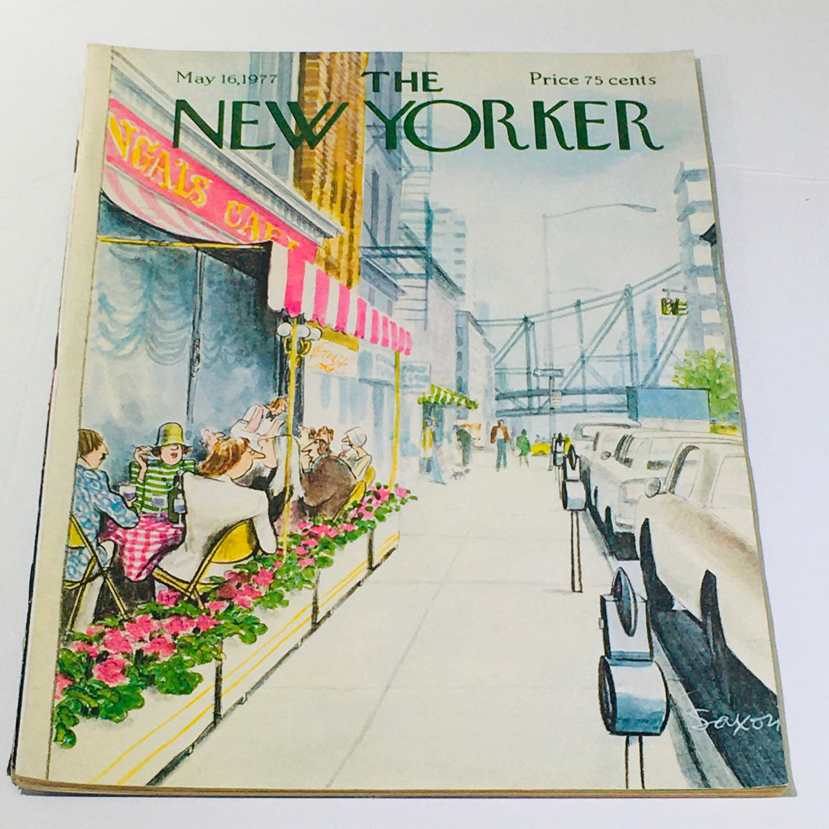 Cover of The New Yorker magazine from May 16, 1977, featuring a vibrant illustration by Charles Saxon depicting a street scene with cafe patrons and a bridge in the background.