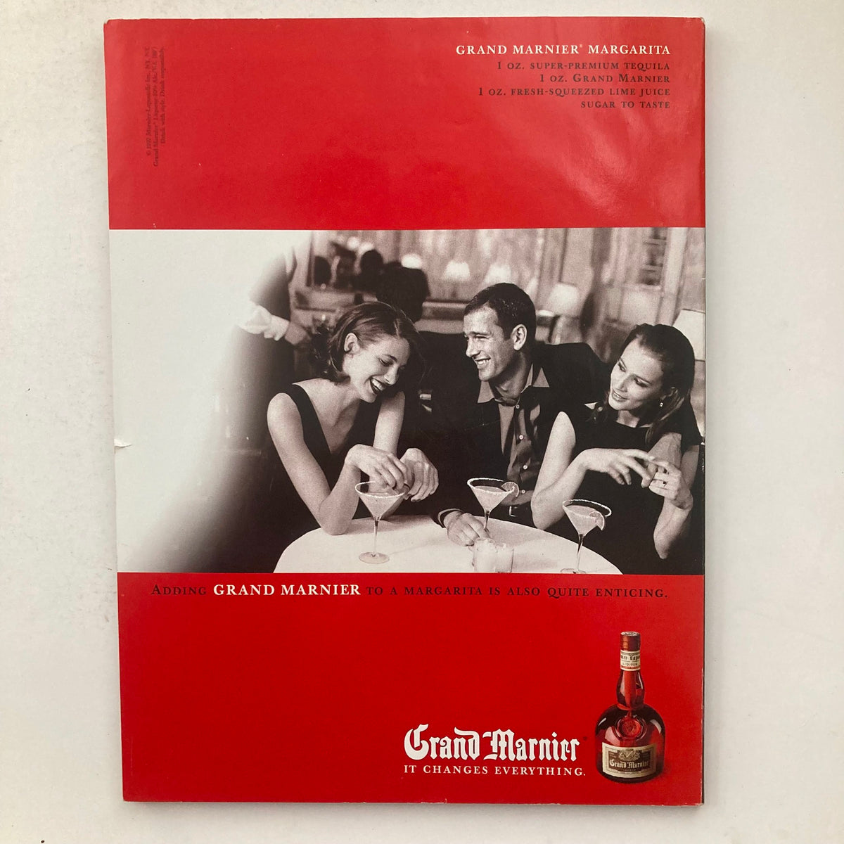 Back cover of Playboy Magazine June 1999 with a vintage advertisement for Grand Marnier featuring a social scene with three friends enjoying cocktails.