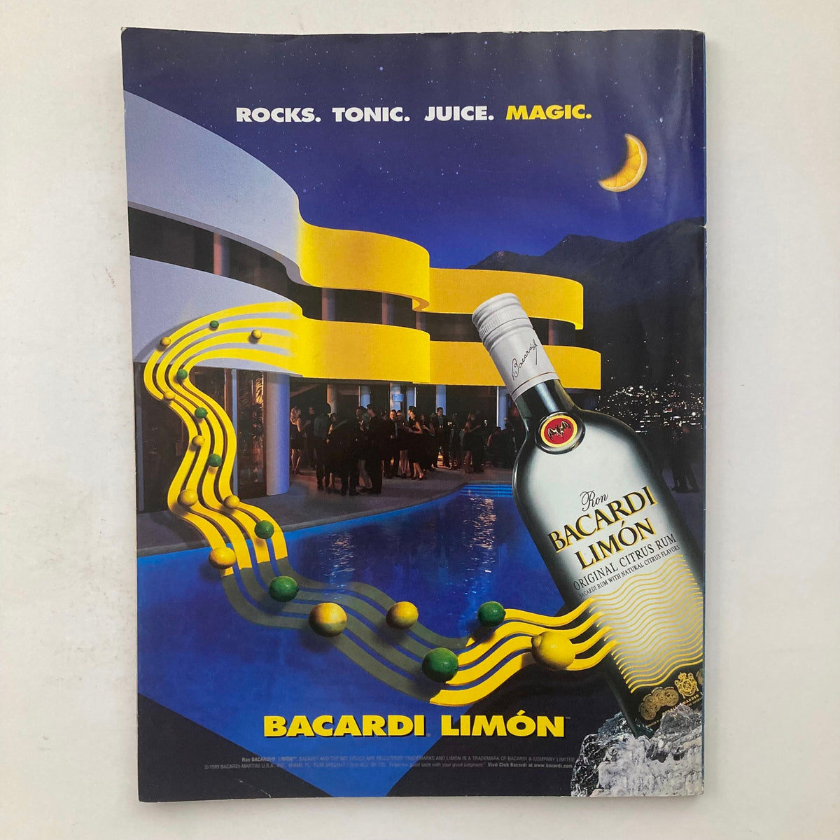 An advertisement page from Playboy Magazine August 1999 for Bacardi Limón, featuring a vibrant nighttime poolside scene.