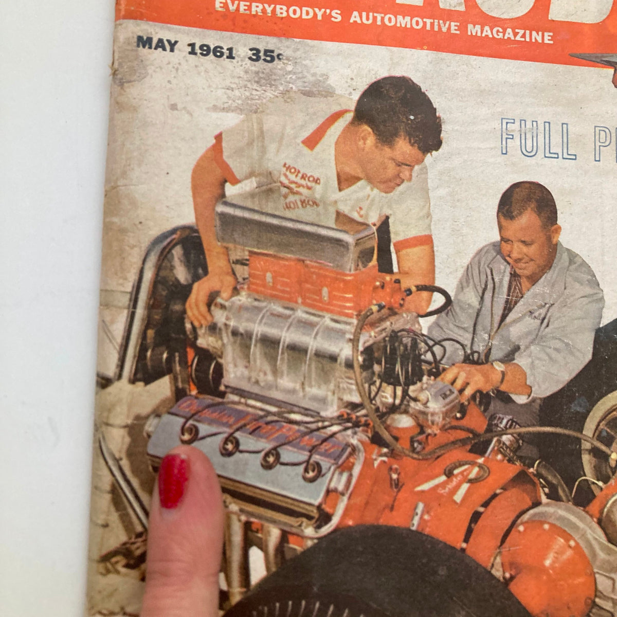 Close-up of the cover of Hot Rod Magazine May 1961, Volume 14, Number 5 showing two men focused on a vintage hot rod engine, illustrating the theme 'All About Alternators'.