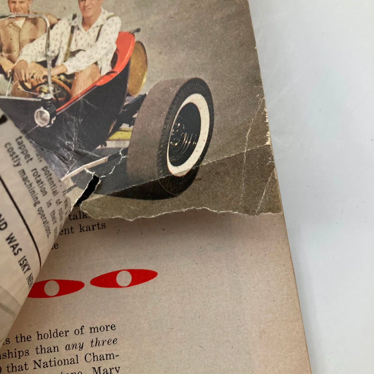 Close-up of the wear and tear on VTG Hot Rod Magazine March 1961 Vol 14 No. 3, featuring a damaged edge of the cover.