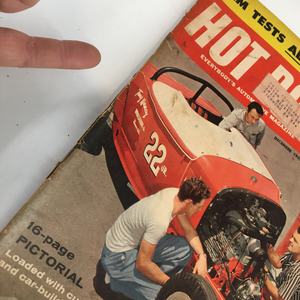 Close-up view of the cover of Hot Rod Magazine December 1957, highlighting a vintage car and two men focusing on automotive customization.