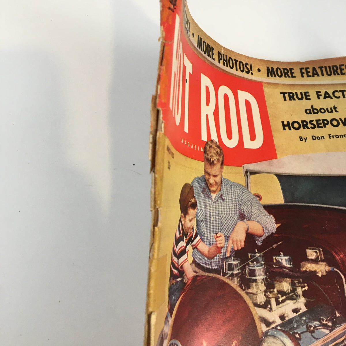 Side view of the cover of VTG Hot Rod Magazine March 1953 highlighting the vintage design and title about horsepower.