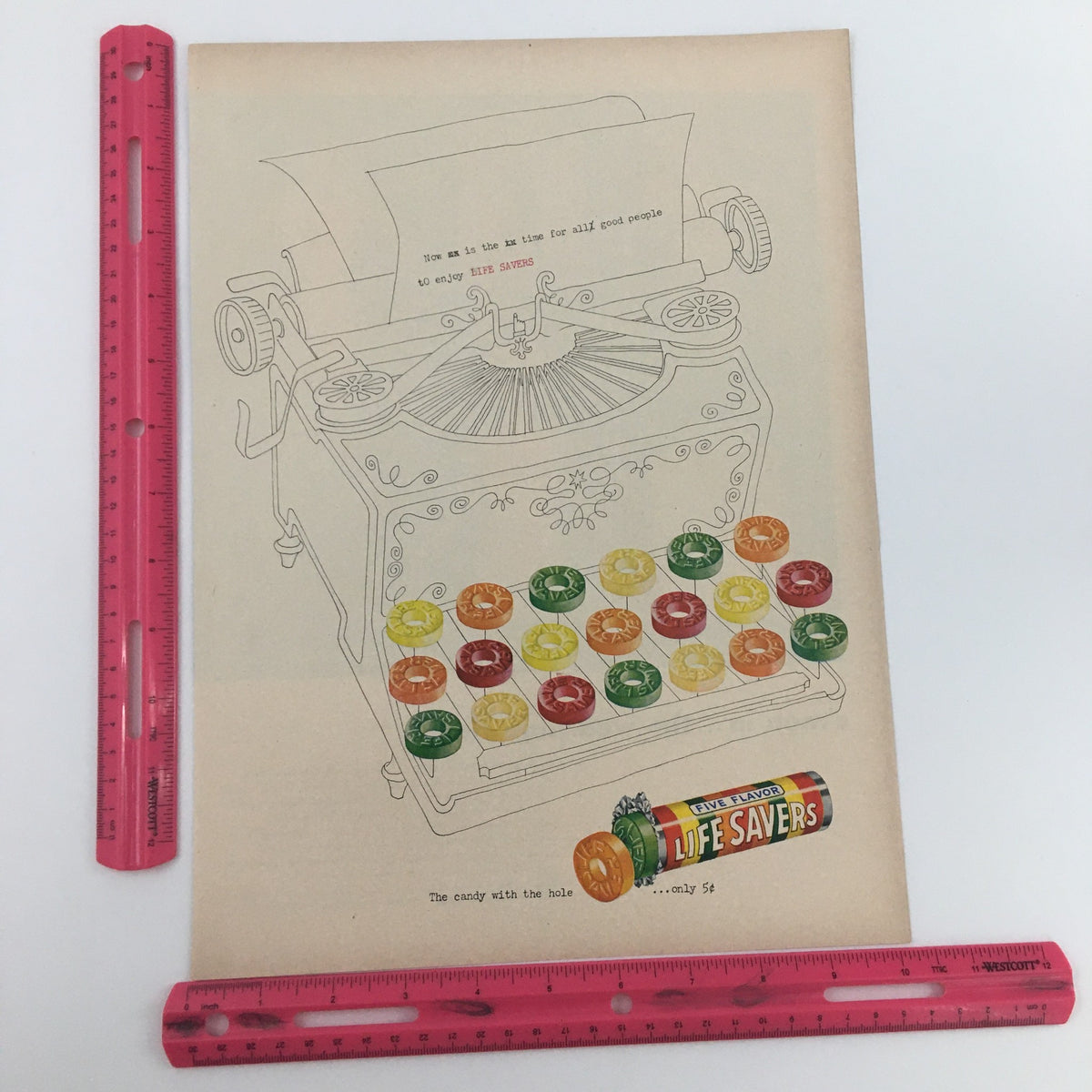 1950 Van Gab Silky-Smooth Gabardine Sport Shirts Print Ad showcasing a retro typewriter with a vibrant assortment of Life Savers candy. An iconic piece reflecting the design aesthetics of the 1950s.