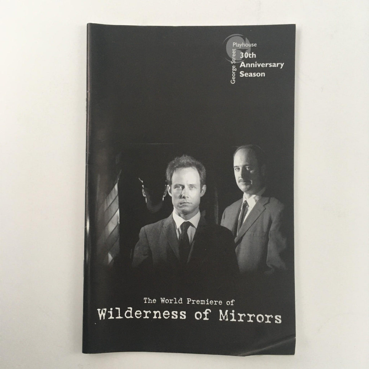 Cover of 'Wilderness of Mirrors' at George Street Playhouse, directed by David Saint, showcasing a scene from the play as part of the 30th Anniversary Season.