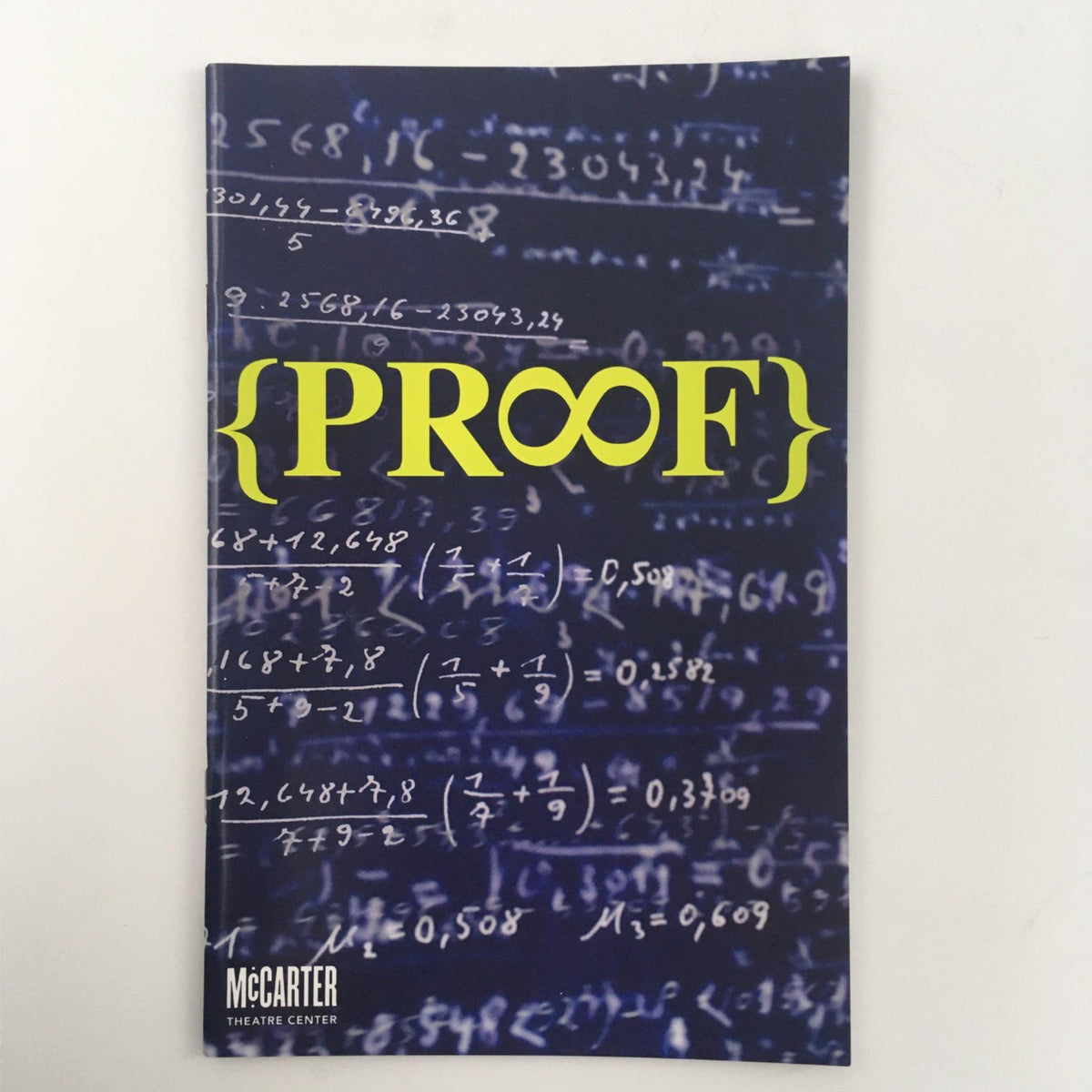 Cover of the 2013 Proof by David Auburn, Emily Mann at McCarter Theatre Center featuring a mathematical background with the title {PROOF} in bold yellow letters.