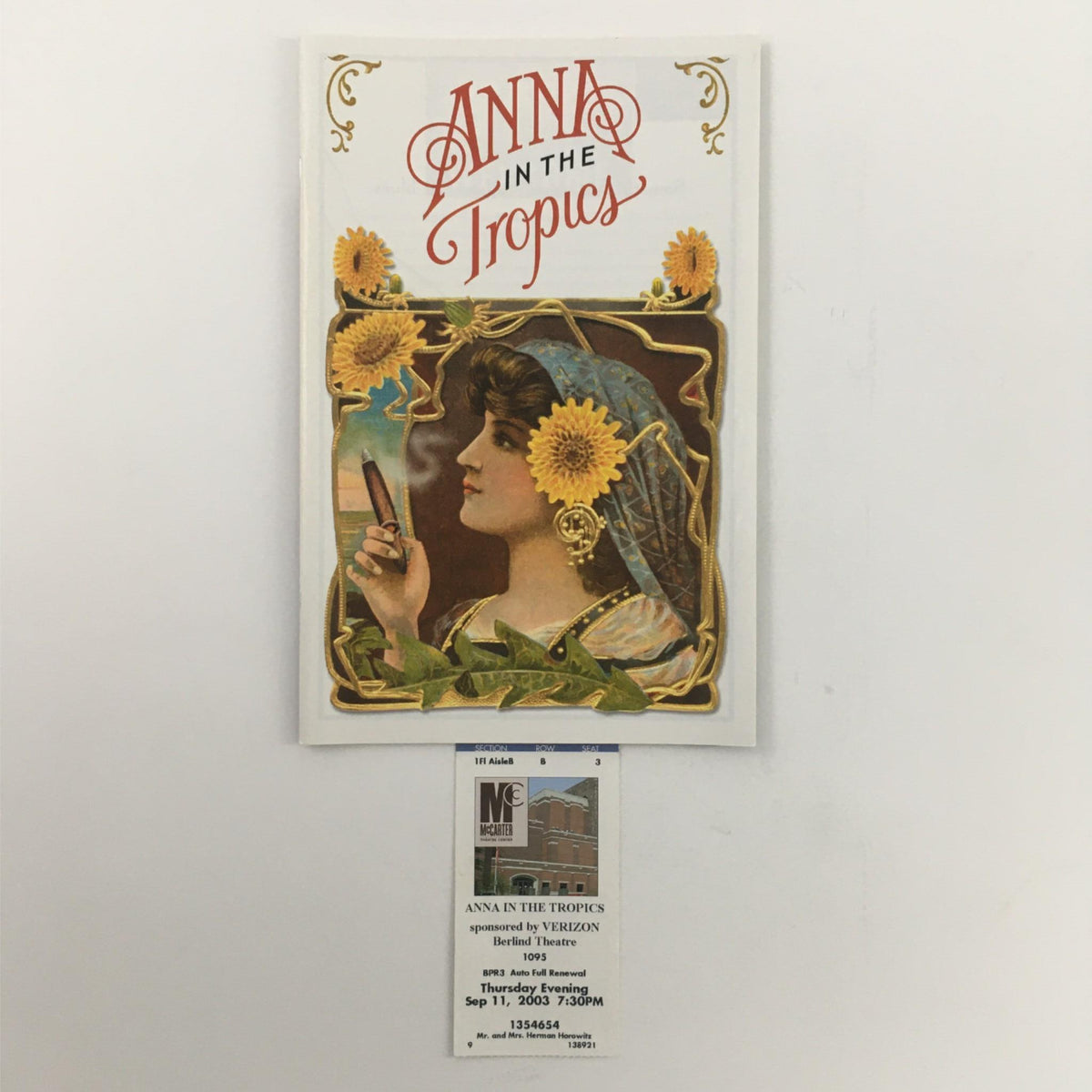 Cover of 'Anna in the Tropics' by Nilo Cruz and Emily Mann, featuring an artistic illustration of a woman holding a cigar with sunflowers. This item is from the 2003 production at McCarter Theatre Center.