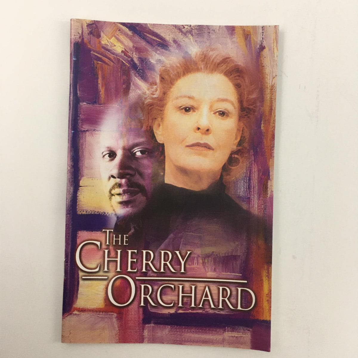 Cover of 'The Cherry Orchard' by Anton Chekhov, directed by Emily Mann at McCarter Theatre, featuring artistic portraits of actors.