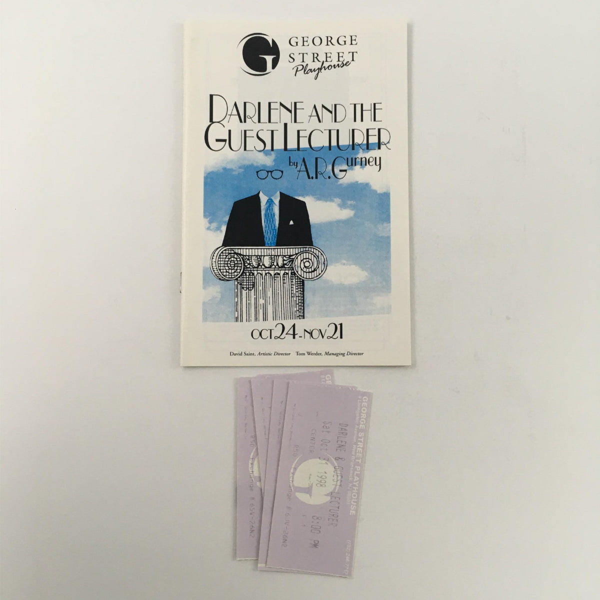 Cover of 'Darlene and the Guest Lecturer' by A.R. Gurney, featuring a stylized illustration with a blue sky background and a prominent column design. The play is presented by the George Street Playhouse from October 24 to November 21.
