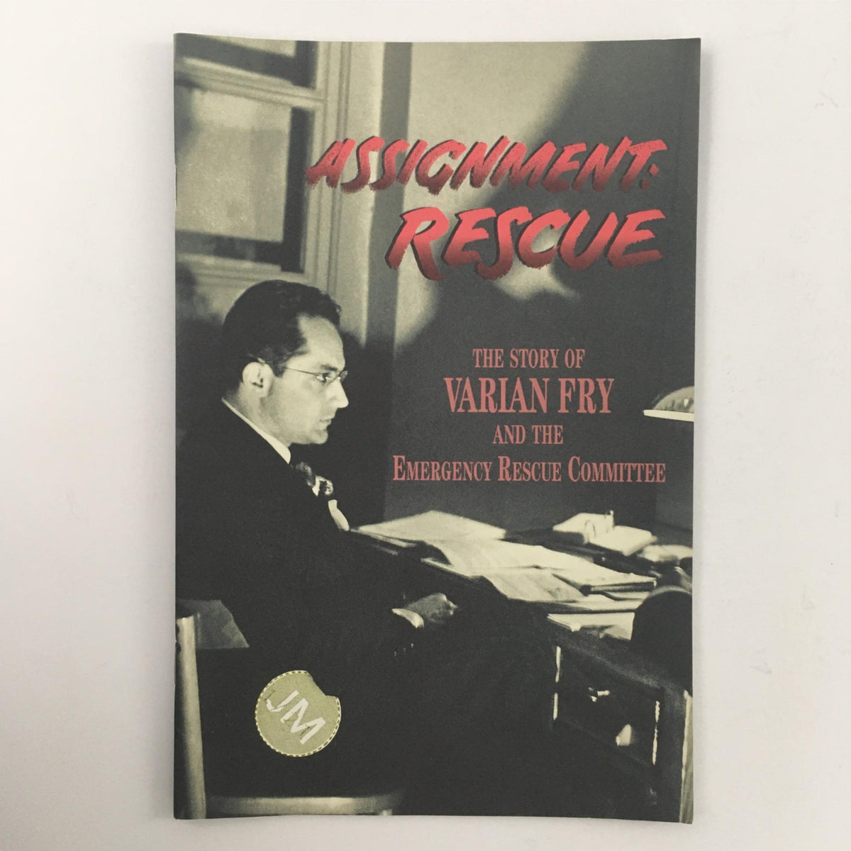 Cover of '1997 Assignment: Rescue The Story of Varian Fry' featuring a black and white photograph of Varian Fry with red title text, highlighting his work with the Emergency Rescue Committee.