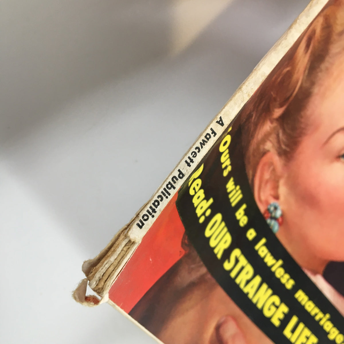 Close-up of the spine of the True Confessions Magazine from September 1952, featuring text about publication and an intriguing advertisement for another story, showcasing the vintage style.
