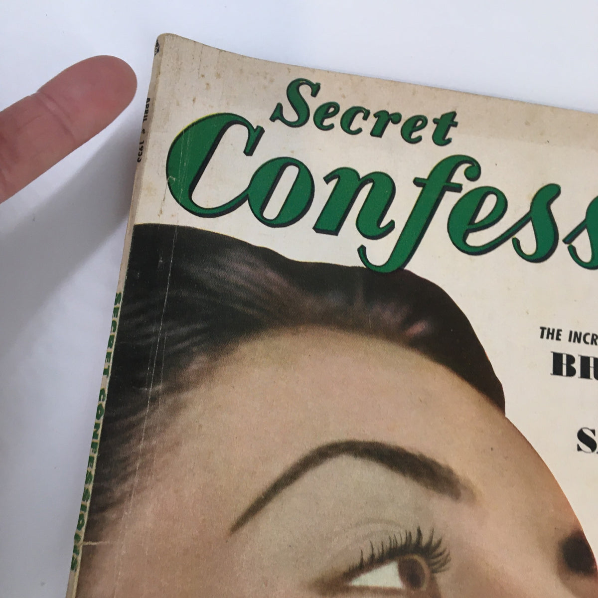 Close-up view of the title 'Secret Confessions' on the April 1953 magazine cover, emphasizing its classic vintage style and unique thematic focus.