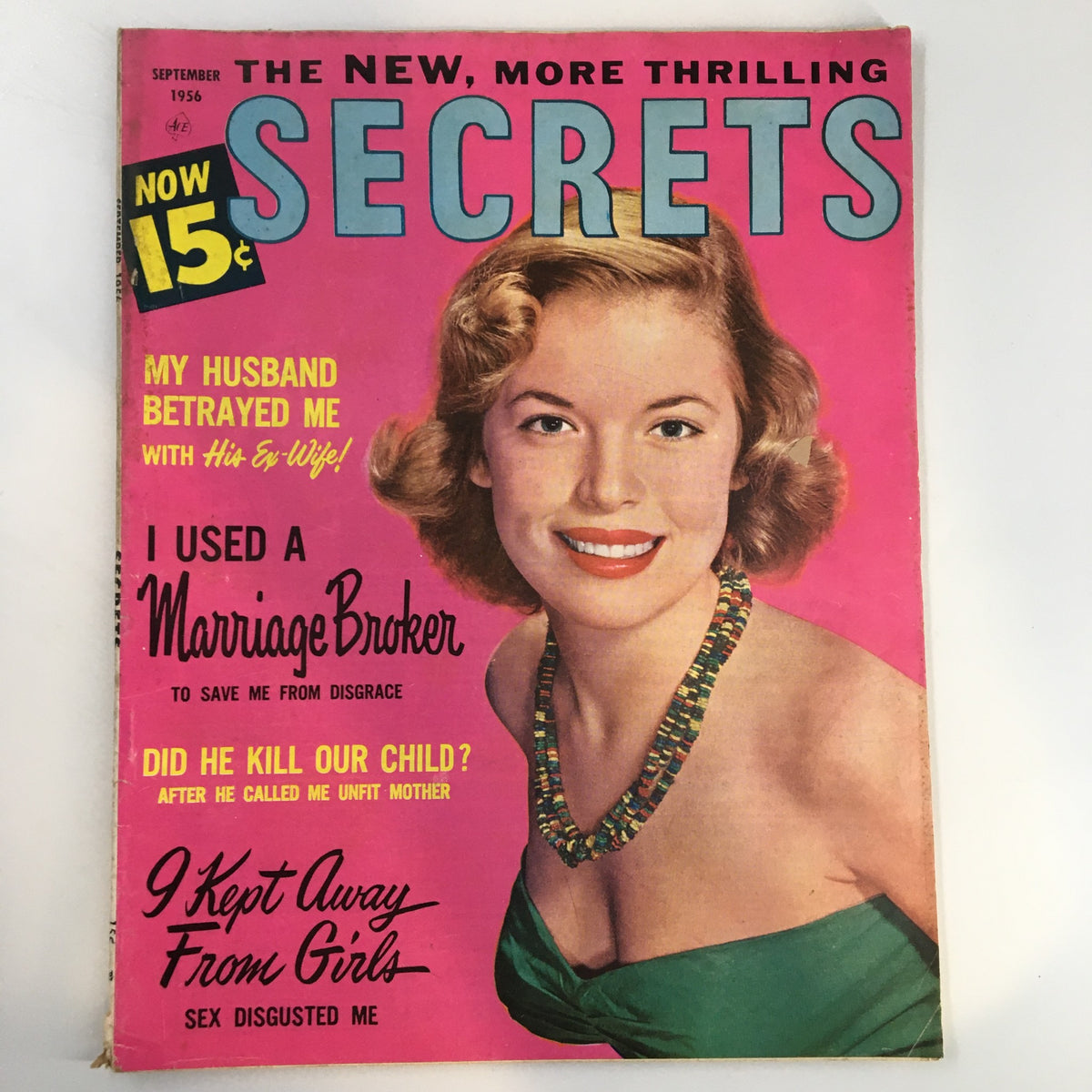 Cover of VTG Secrets Magazine September 1956 featuring the headline 'I Used A Marriage Broker', vibrant pink background, and an illustration of a smiling woman, representing 1950s culture.
