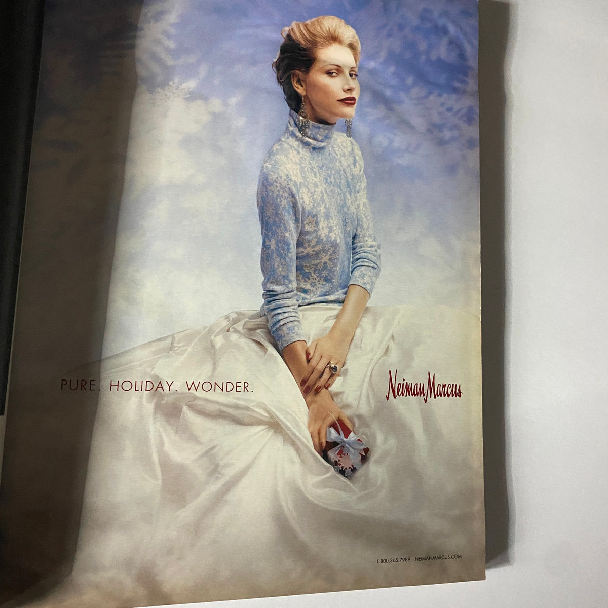 Advertisement page from W Magazine December 2003 featuring a winter-themed fashion spread by Neiman Marcus, showcasing seasonal elegance.