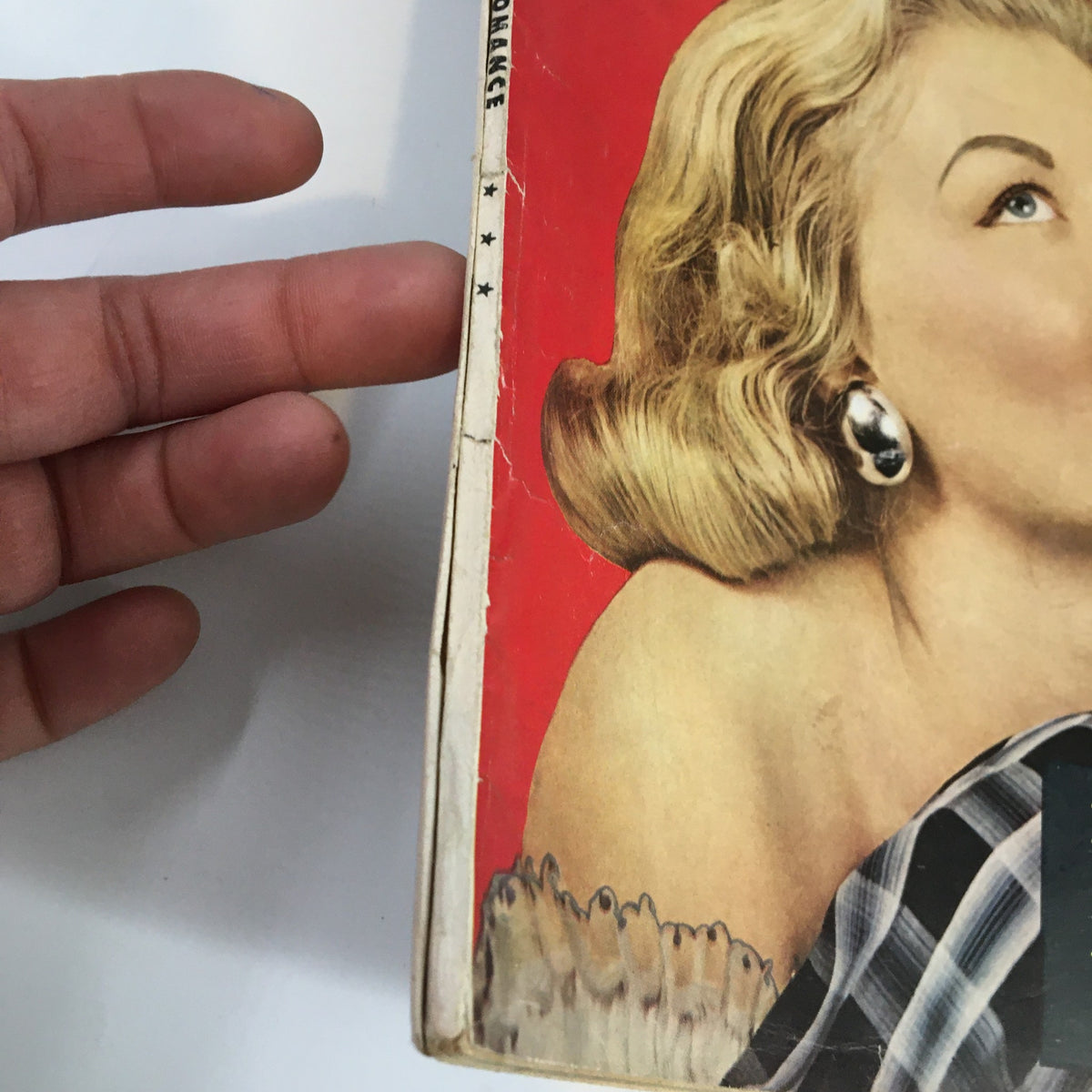 Close-up view of the spine and cover of My Romance Magazine, October 1958 edition showcasing its vintage condition and details related to 'I Married A Dying Millionaire'.